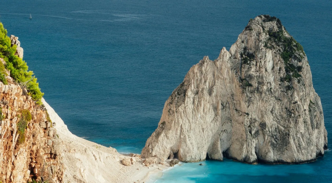 The Mizithres limestone stacks seen from the cliffs above with a beach below