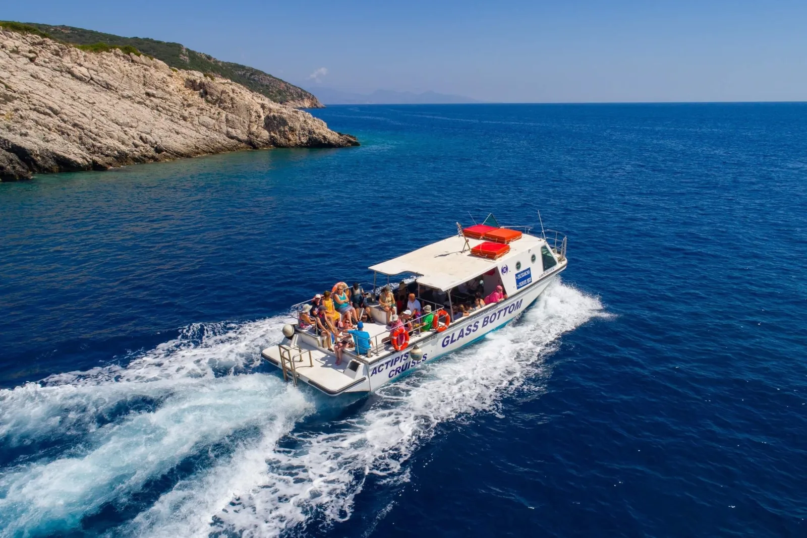 The glass-bottom boat speeding across deep blue water off the north coast