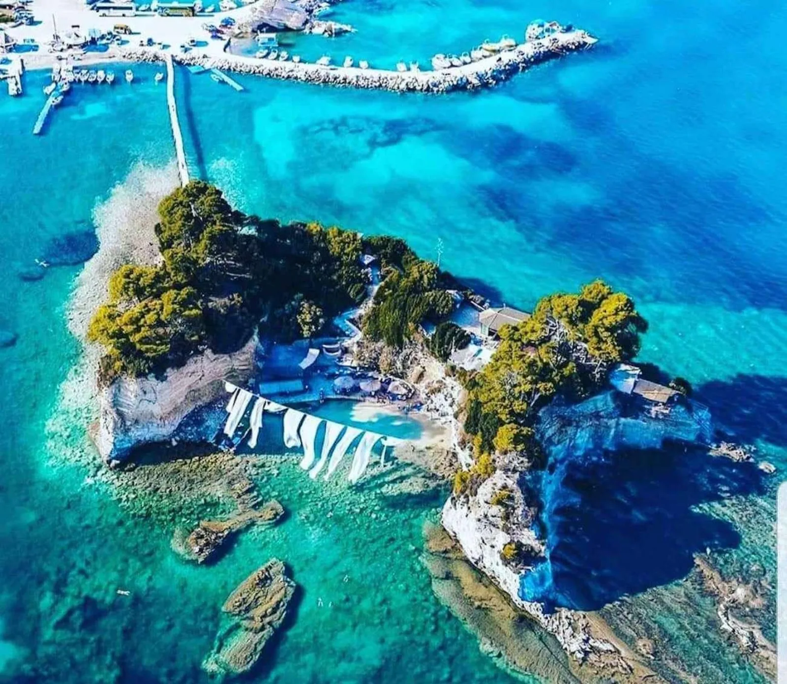 Aerial view of Cameo Island and its footbridge at Agios Sostis harbour