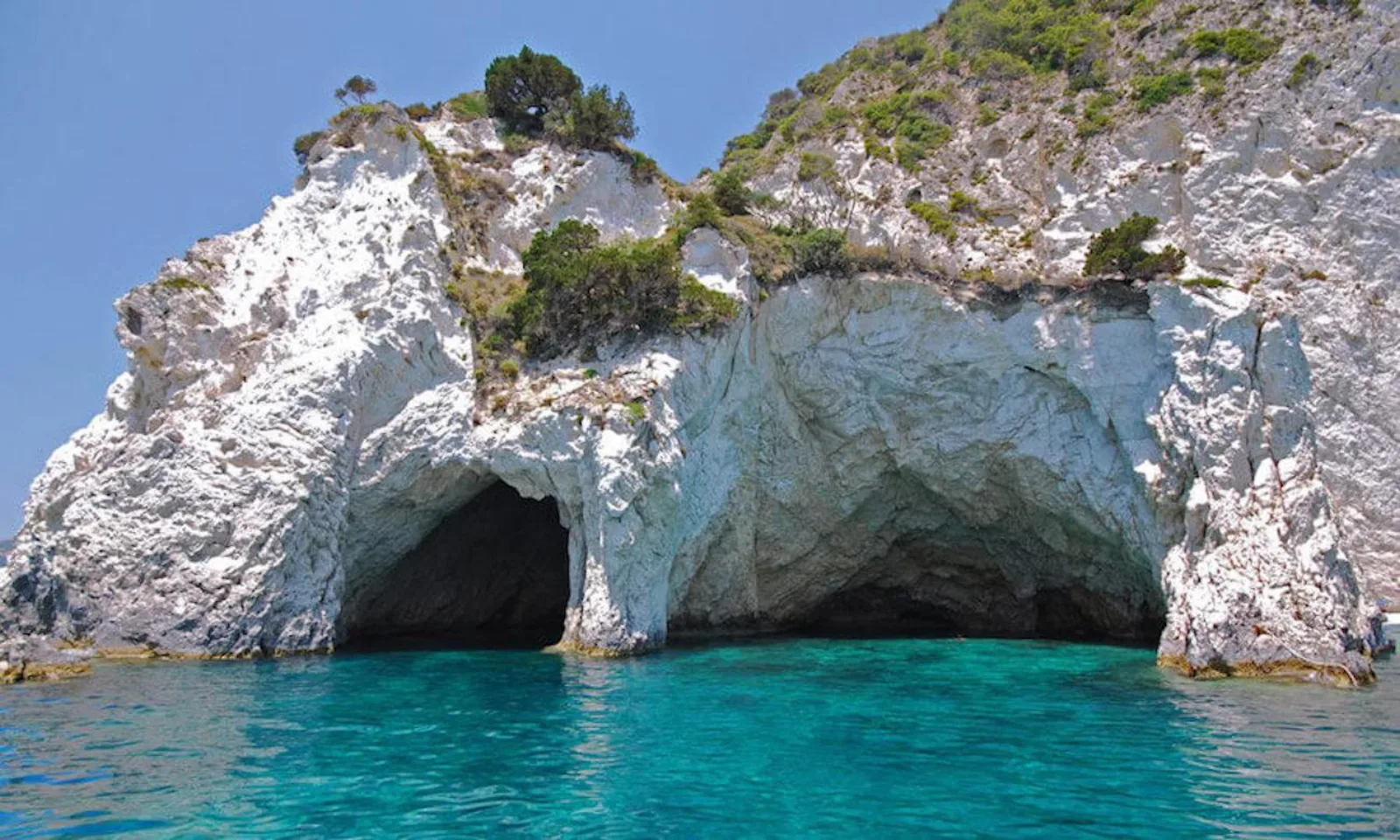 A sea cave mouth in the white limestone of the Keri cliffs