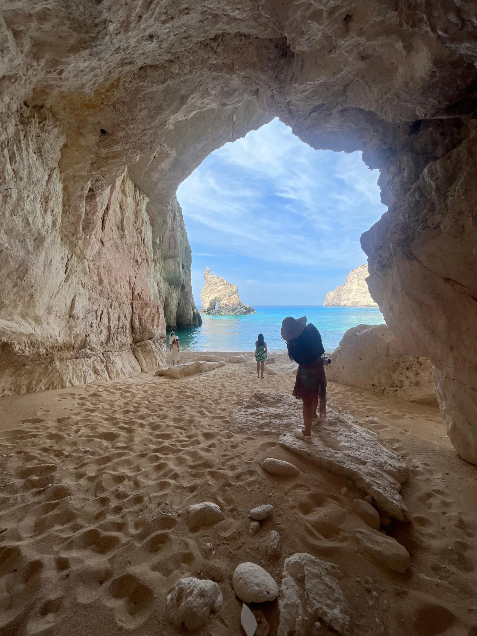 Looking out from the pebble floor of a sea cave through its mouth to the open sea