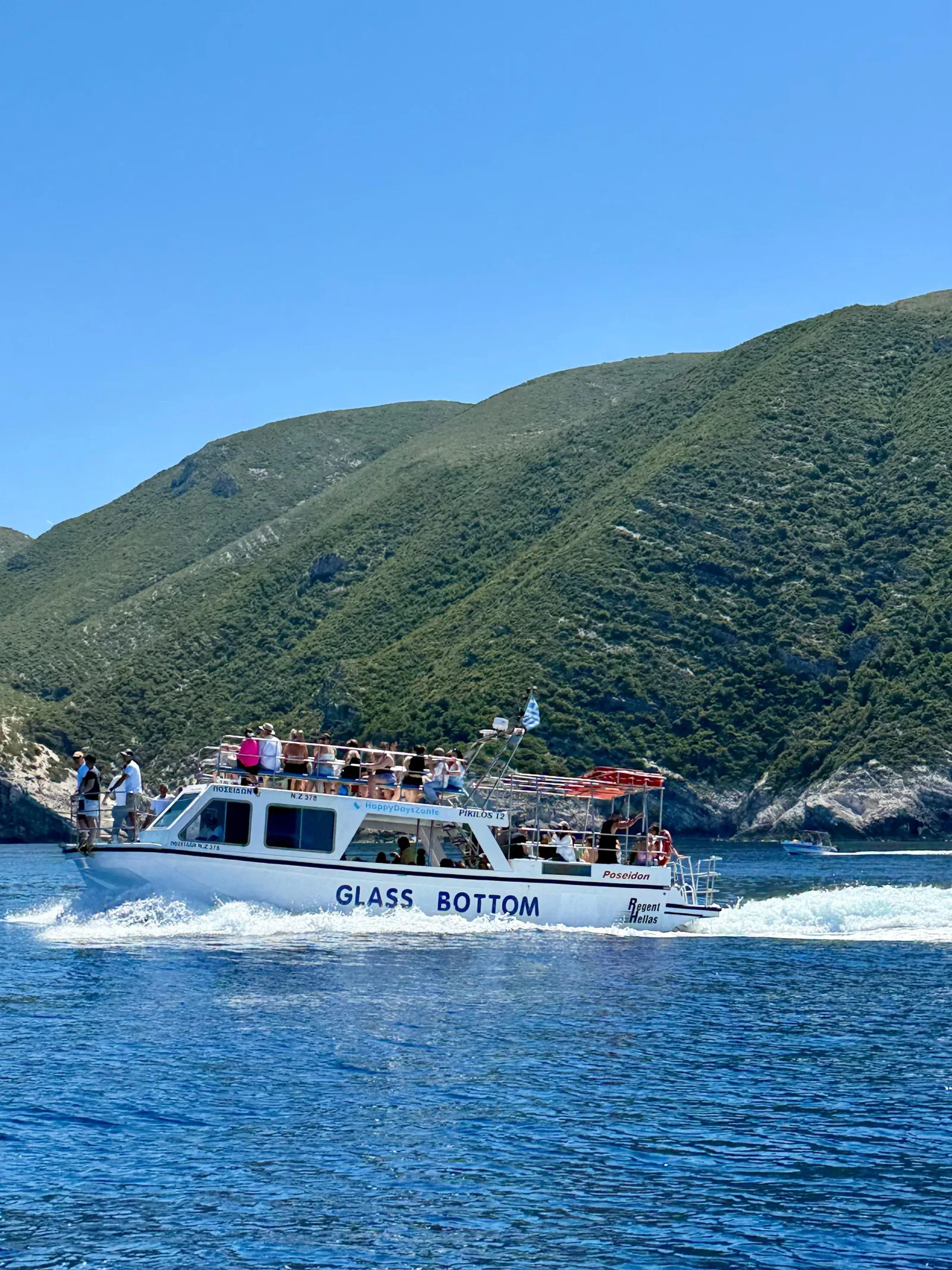 The glass-bottom boat under way along the green west coast of Zakynthos