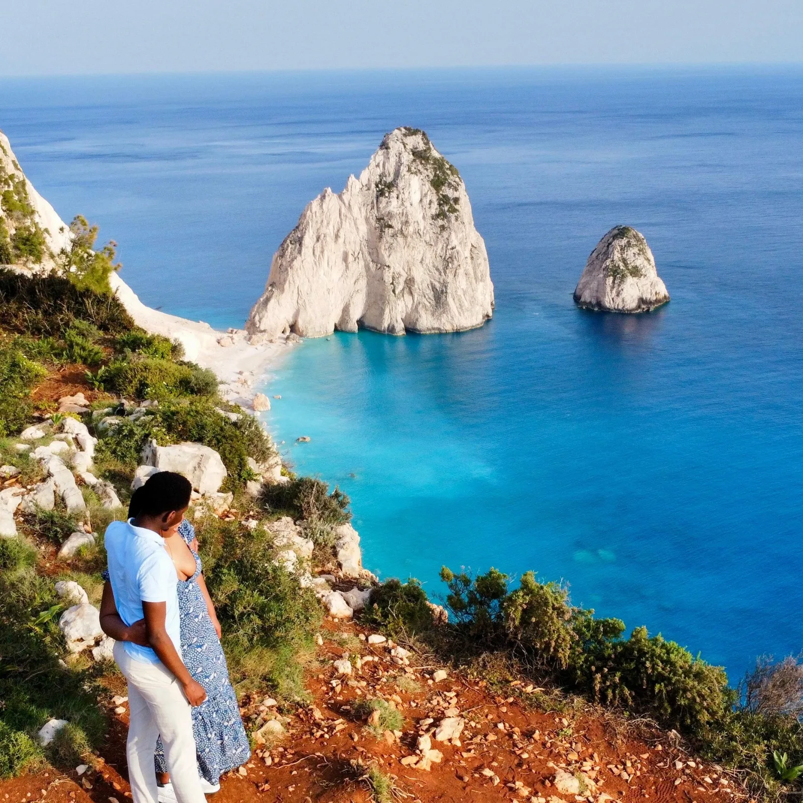 Visitors at the clifftop viewpoint above the Mizithres sea stacks
