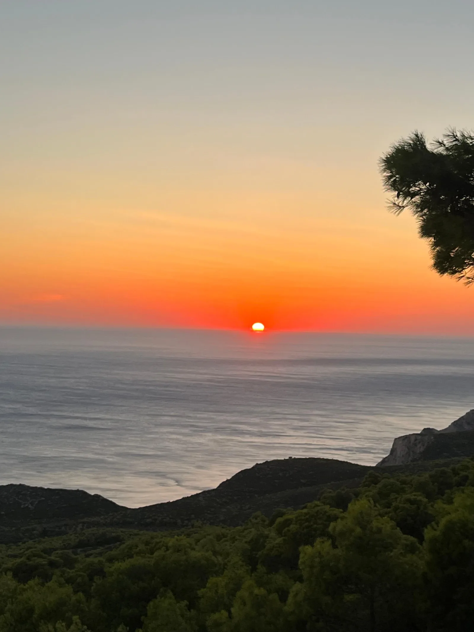 The sun setting into the Ionian Sea from the hills above Agalas