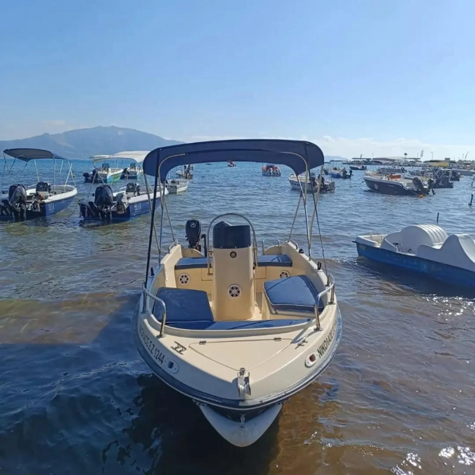 The rental speedboat with its sun canopy at Agios Sostis harbour