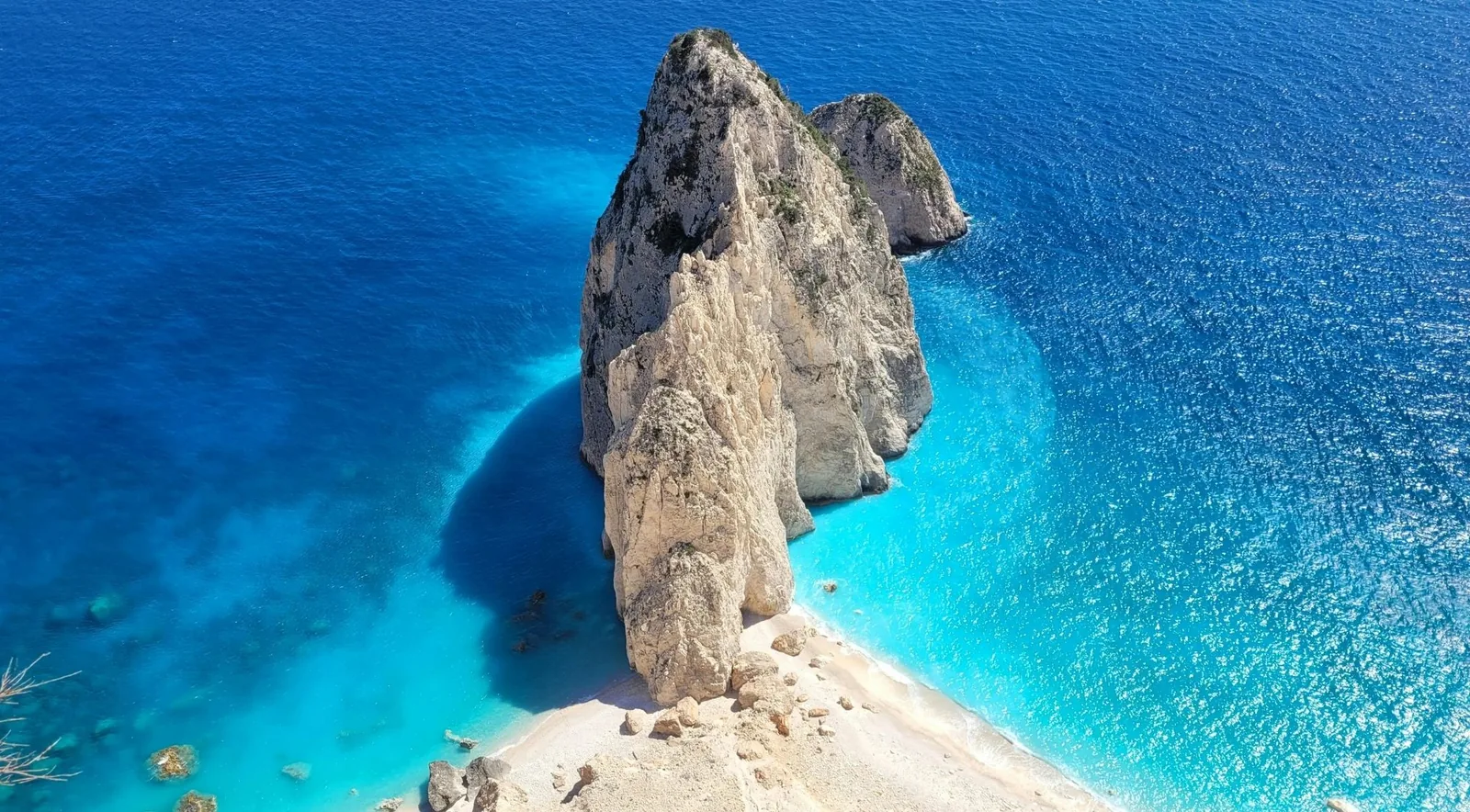 Aerial view of the Mizithres sea stacks off Cape Keri in turquoise water